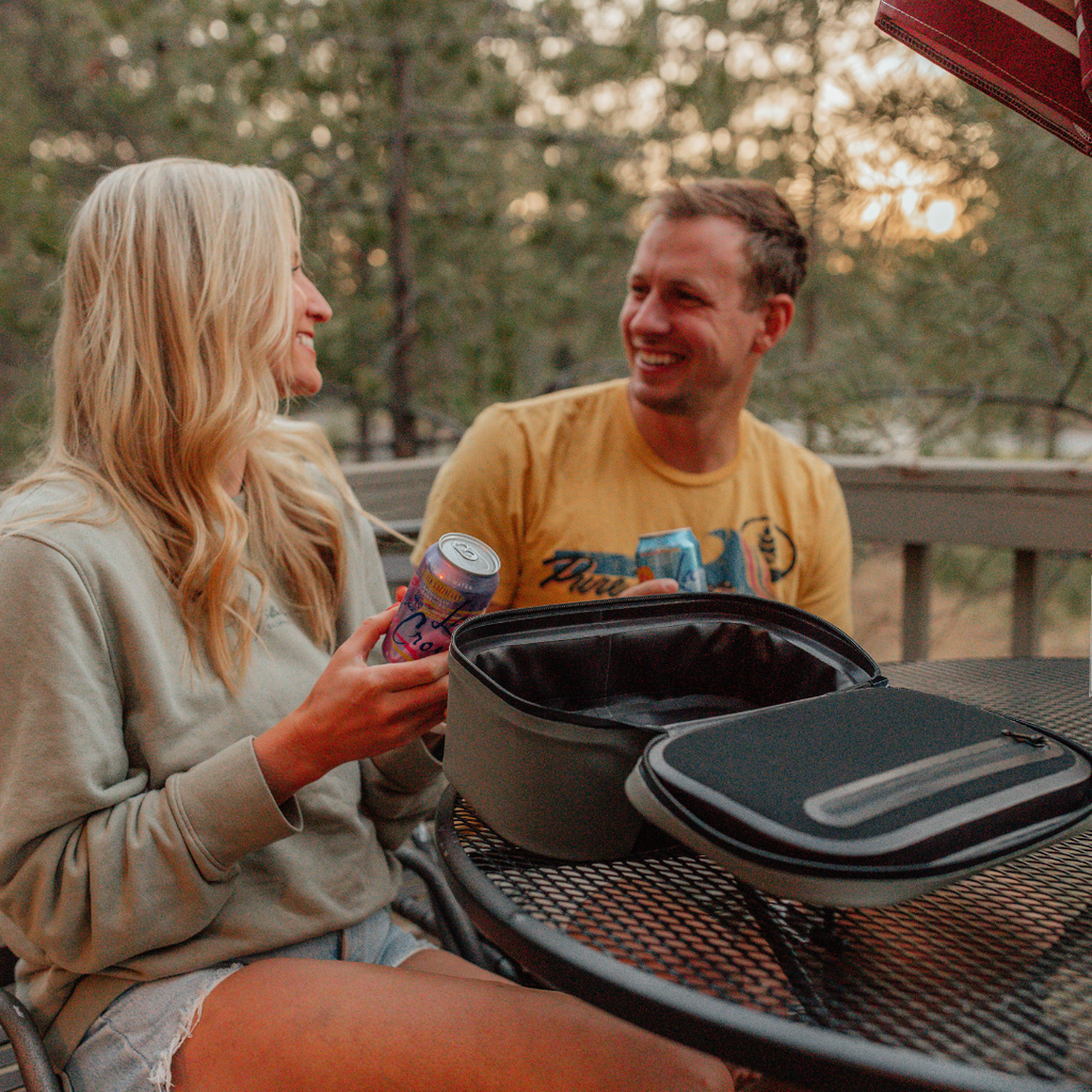 BACKCOUNTRY CLASS™ COOLER LUNCH BAG in black ballistic fabric, open with a matching zippered lid and carrying handle