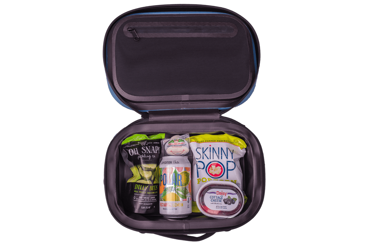 BACKCOUNTRY CLASS™ COOLER LUNCH BAG in black ballistic nylon, open with snacks, a drink can and cheese inside