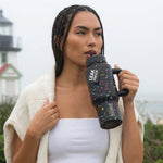 COLDEST 24oz Limitless bottle in black with colorful star patterns, a flip-top lid, and a sturdy side handle