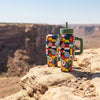 COLDEST 24oz Limitless bottle with a colourful geometric patchwork pattern, green lid, handle, and straw