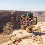 COLDEST 24oz Limitless bottle with a colourful geometric patchwork pattern, green lid, handle, and straw