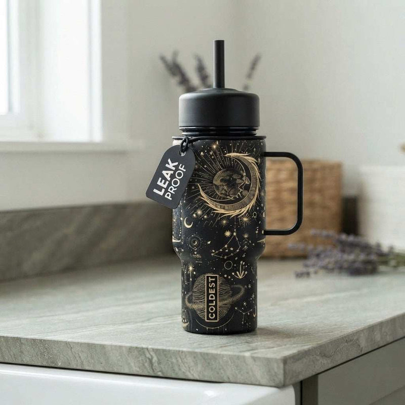Coldest Mini 6.7oz Insulated Water Bottle in black with gold celestial moon and stars design, straw lid and side handle
